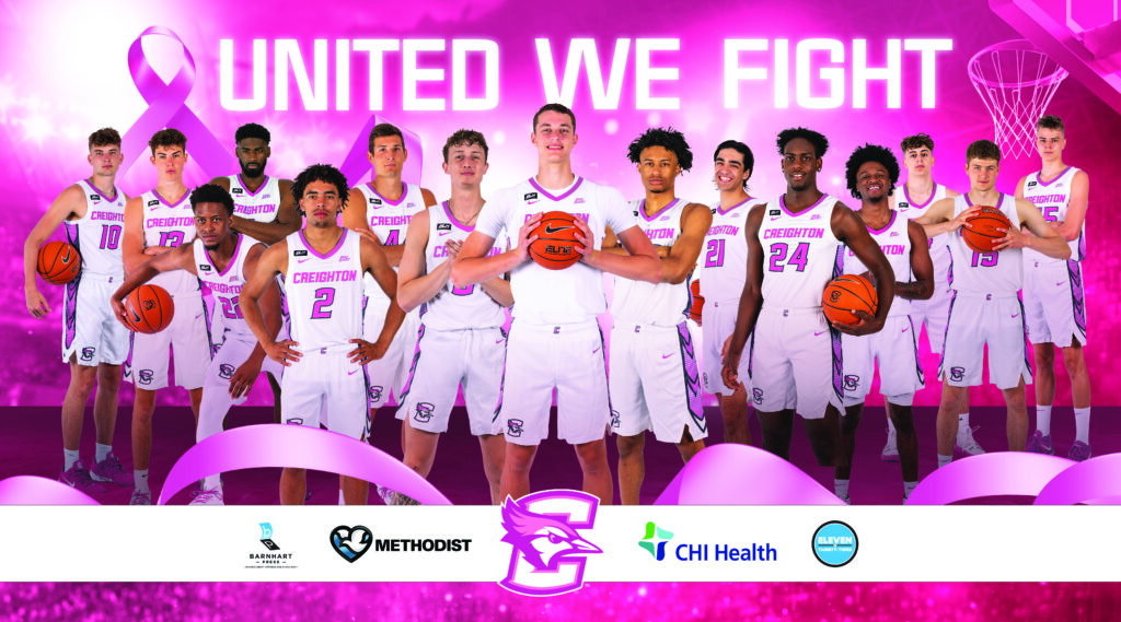 Basketball team united in the fight against cancer, standing strong with determination and support for the cause.